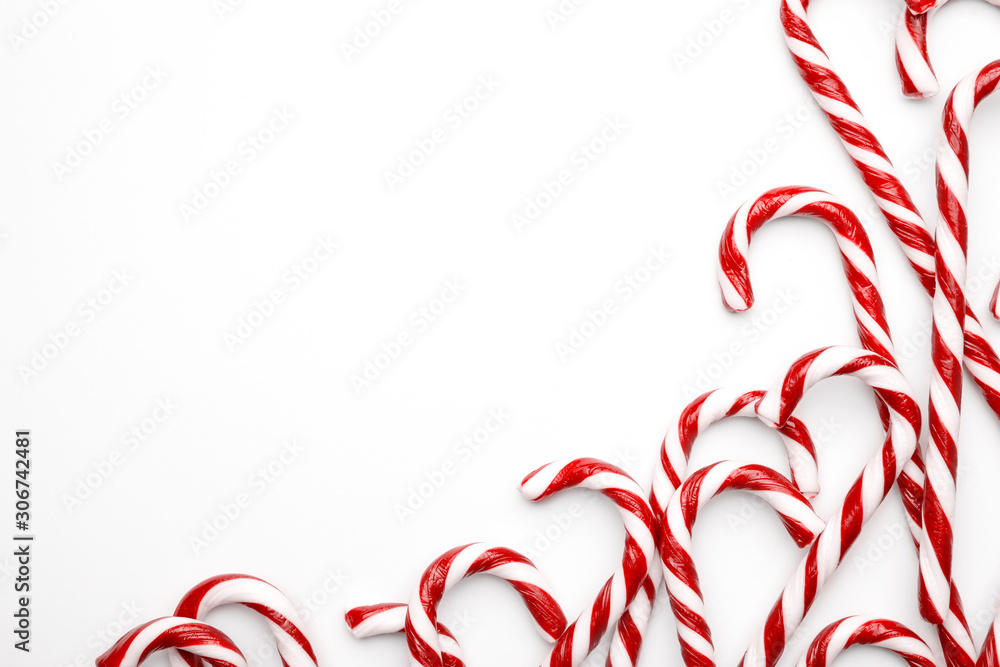 Frame made with Christmas candy canes on white background. Minimal