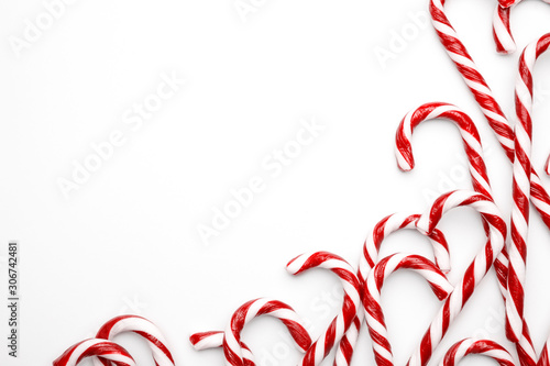 Frame made with Christmas candy canes on white background. Minimal composition with peppermint candies. Top view