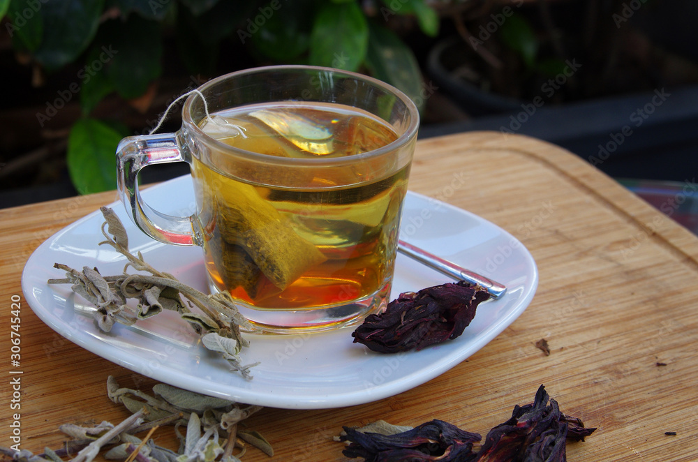 a cup of salvia tea served with raw salvia a cup of salvia tea served with raw salvia