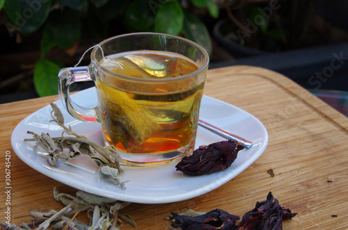 a cup of salvia tea served with raw salvia