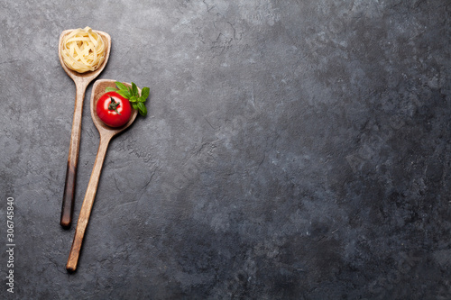 Pasta and ingredients in spoons