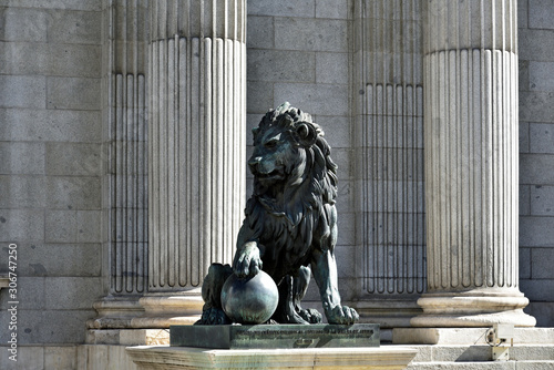 MADRID / SPAIN - APRIL 11, 2019 - Lion sculpture in front of Building of Congress of Deputies Congreso de los Diputados in City.