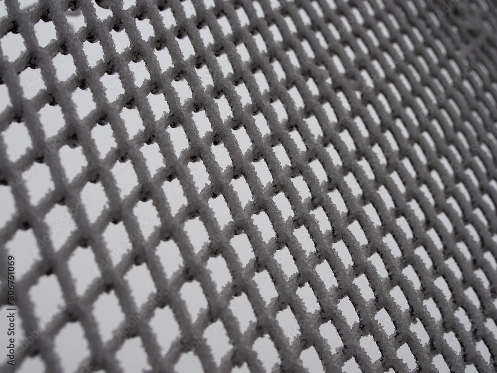 close-up metal mesh covered with a thick layer of snow in the cells close-up metal mesh covered with a thick layer of snow in the cells