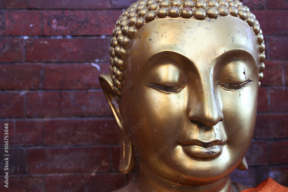 Face image of Golden Buddha statue at Thai temple, Bangkok, Thailand