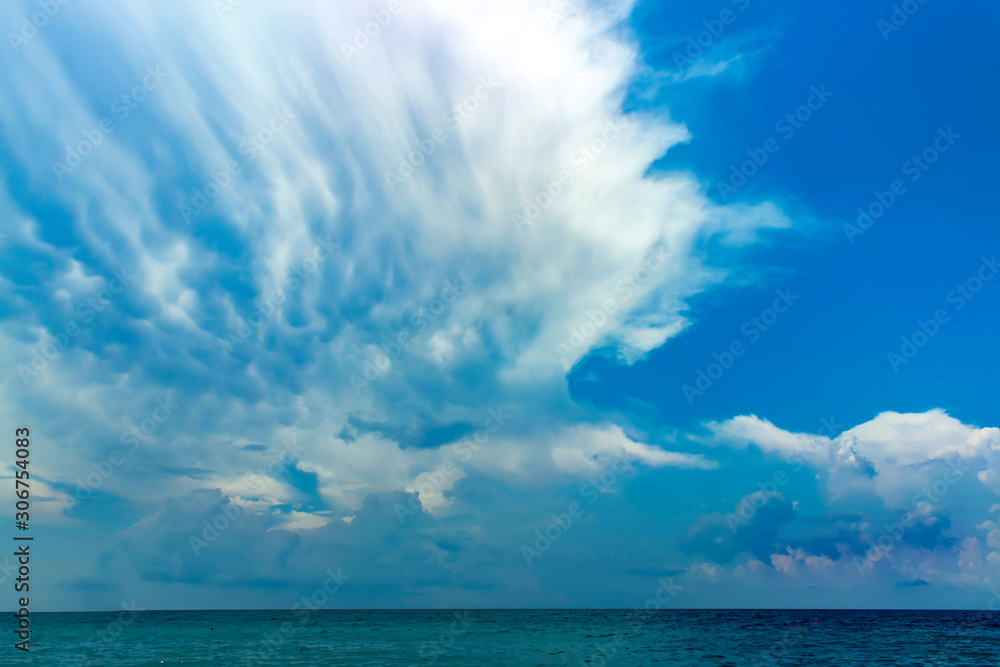 Blue sky with clouds over sea. Summer background.