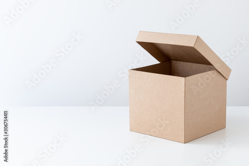 Half-open cardboard box, gift box, isolated on white.