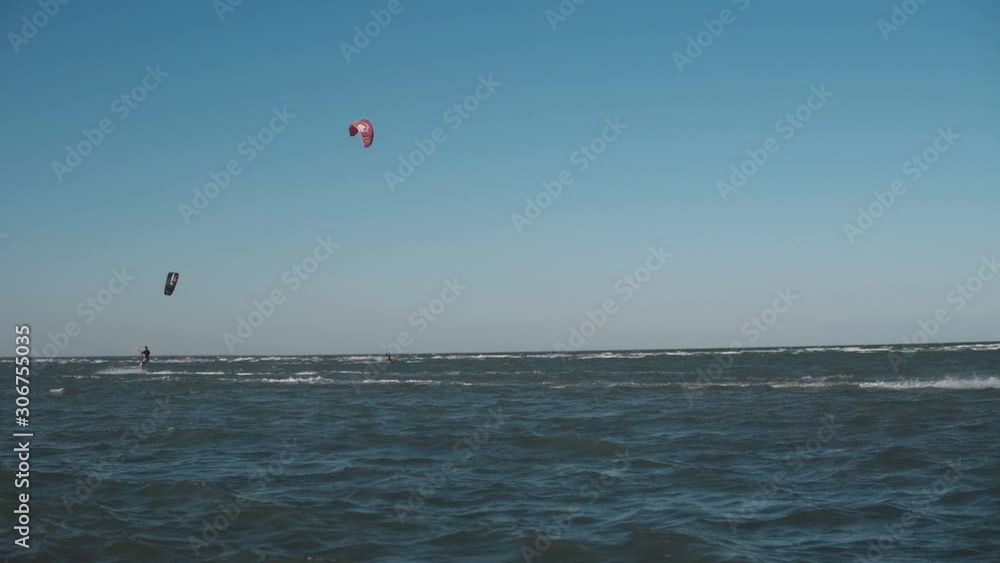 Extreme Kite Boarding Trick Over Camera In Sea. Young Man Kitesurfing in sea Extreme Kite Boarding Trick Over Camera In Sea. Young Man Kitesurfing in sea
