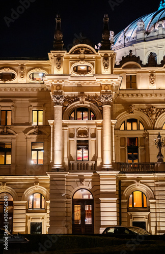 Side view of monumental, rich decored with sculptures and ornaments building of Juliusz Slowacki Theatre in Cracow (Krakow) old town in Poland at night