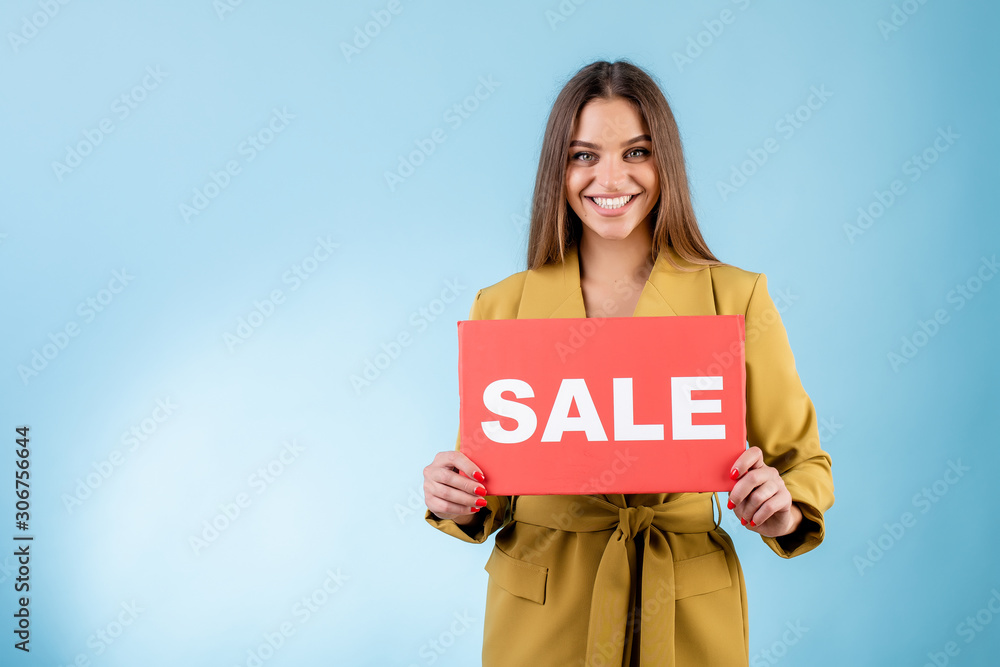 smiling woman holding copy space red sale sign isolated over blue smiling woman holding copy space red sale sign isolated over blue