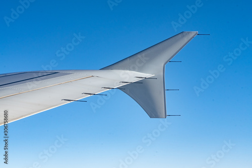 views of the plane's wing and the clear blue sky