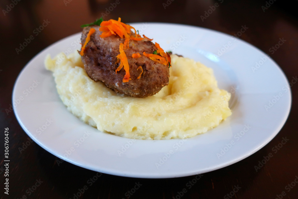 cutlet with mashed potatoes and grated carrot served for the second cutlet with mashed potatoes and grated carrot served for the second