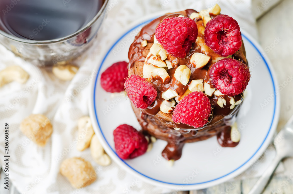 chocolate pancake with bananas, nuts, chocolate sauce and glass of coffee chocolate pancake with bananas, nuts, chocolate sauce and glass of coffee
