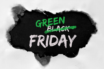 Green Friday concept with hole burned in white paper. Text "Black Friday Sale"  with word "Black" being crossed out to be replaced with "Green" instead.