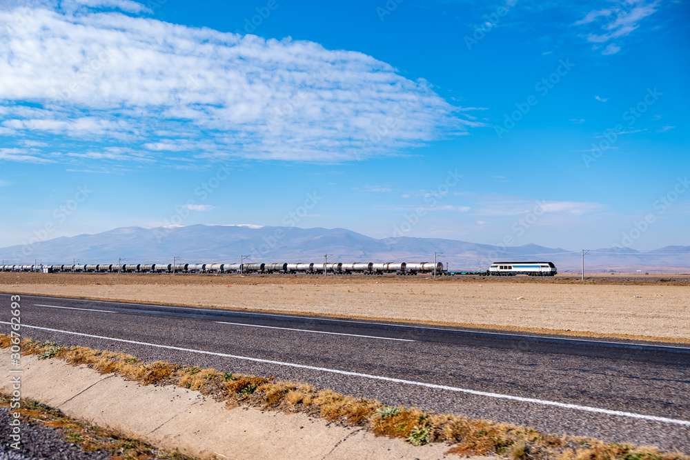 Railroad train of tanker cars transporting crude oil. Railroad train of tanker cars transporting crude oil.