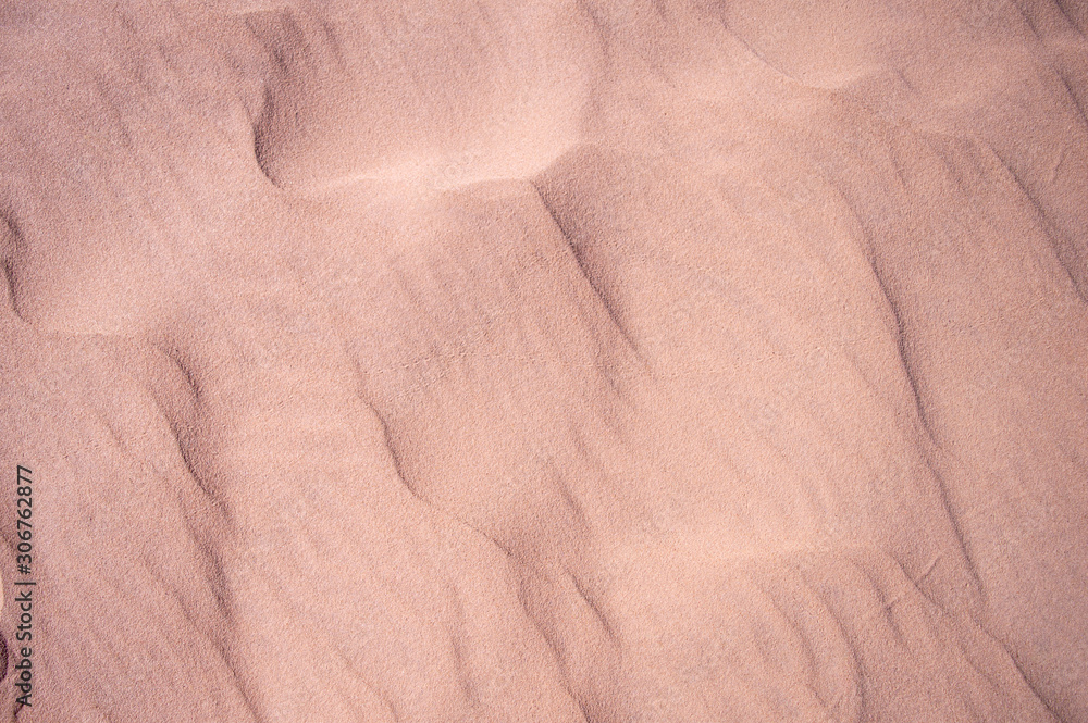Summer rose sand dune pattern for background. Close-up of patterns in a sand dune with ripples, sand texture Summer rose sand dune pattern for background. Close-up of patterns in a sand dune with ripples, sand texture