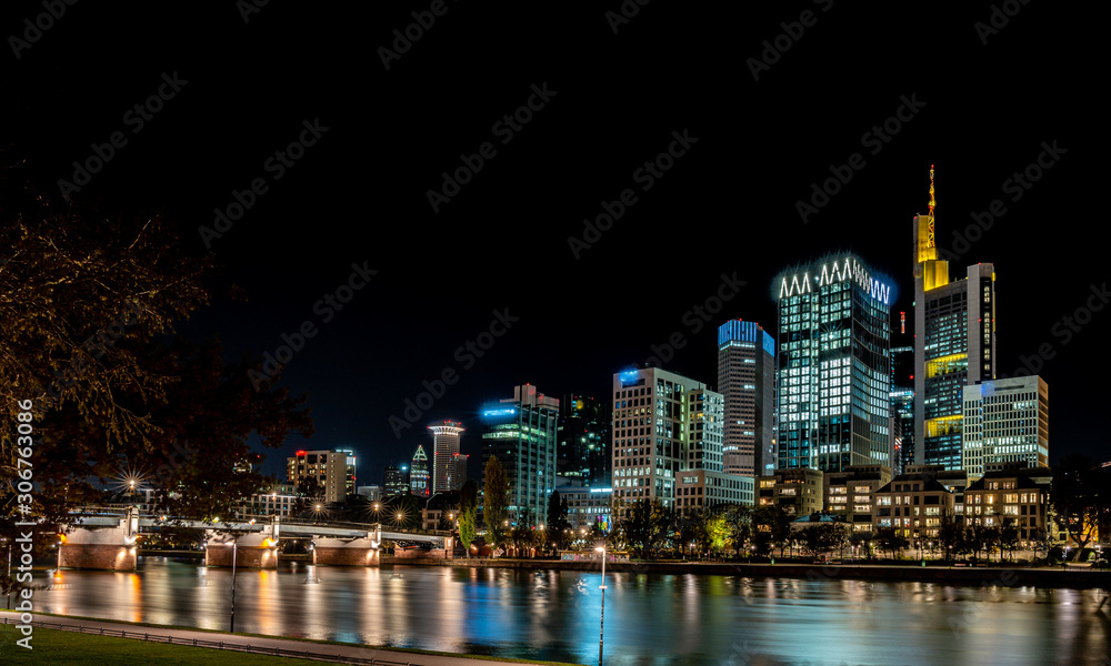 frankfurt skyline at night with colorful reflections in the main river, frankfurt am main, germany