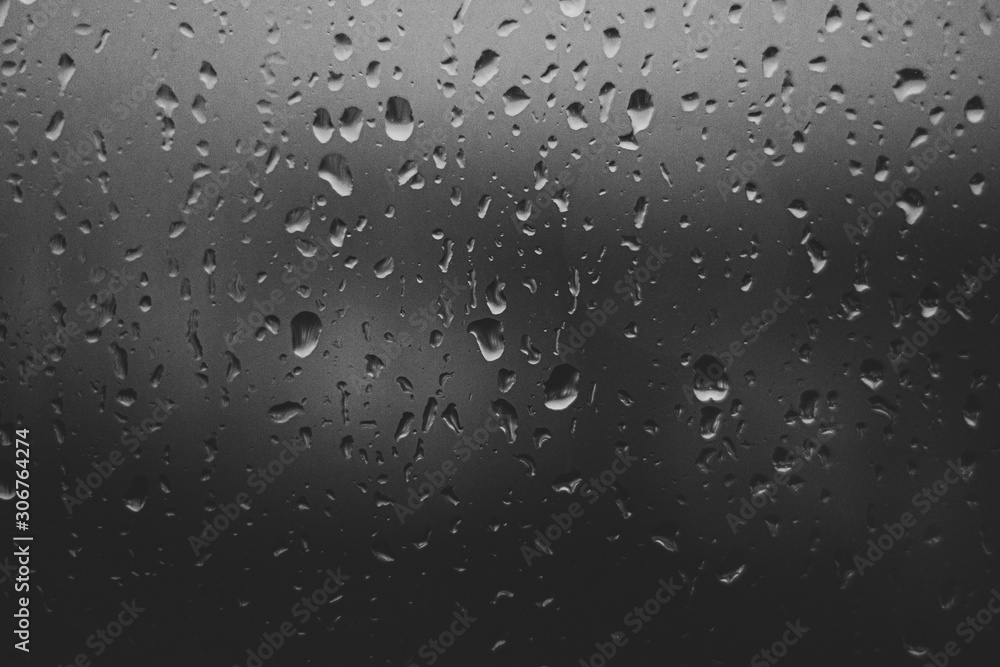 blue rain drops on glass background black and white