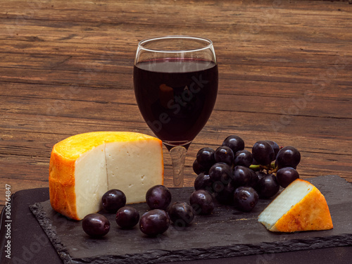 Pure Spanish goat cheese with grapes and a glass of red wine. (cheese from Extremadura. South of Spain)