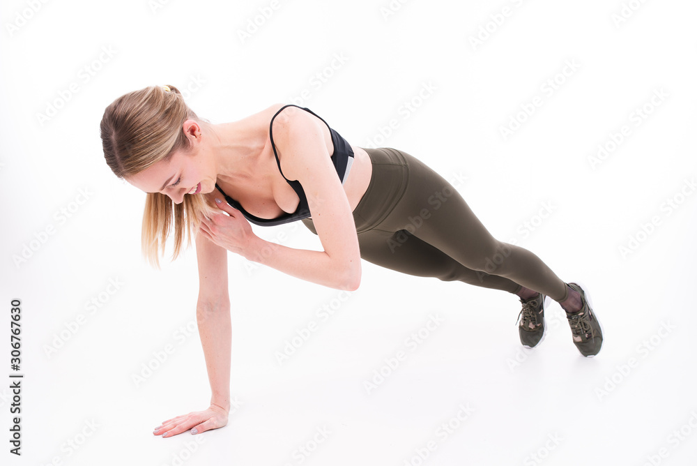 Young beautiful girl goes in for sports on white background Young beautiful girl goes in for sports on white background