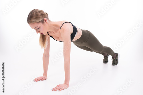 Young beautiful girl goes in for sports on white background