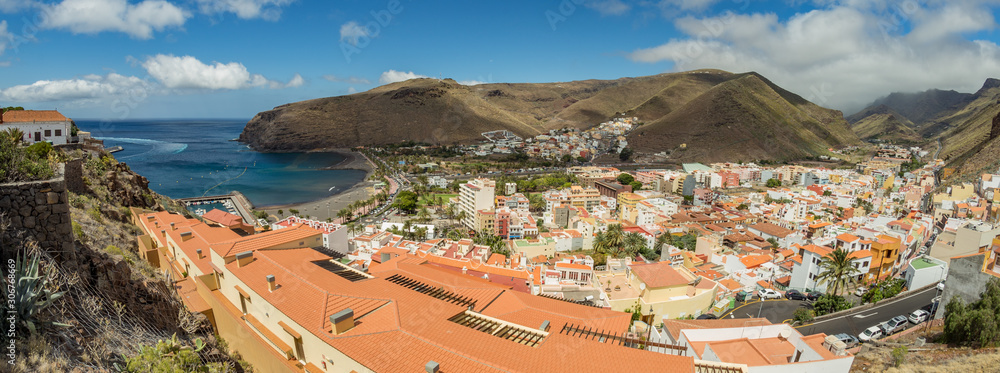 Aerial view from mountains to the main port of the island of La Gomera. Colorful roofs and houses on slope of Volcano in San Sebastian de la Gomera, Spain