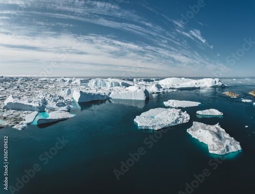 Iceberg and ice from glacier in arctic nature landscape in Ilulissat,Greenland. Aerial drone photo of icebergs in Ilulissat icefjord. Affected by climate change and global warming.