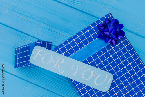 Blue gift box and for you note. Top view. Blue wooden background. photo