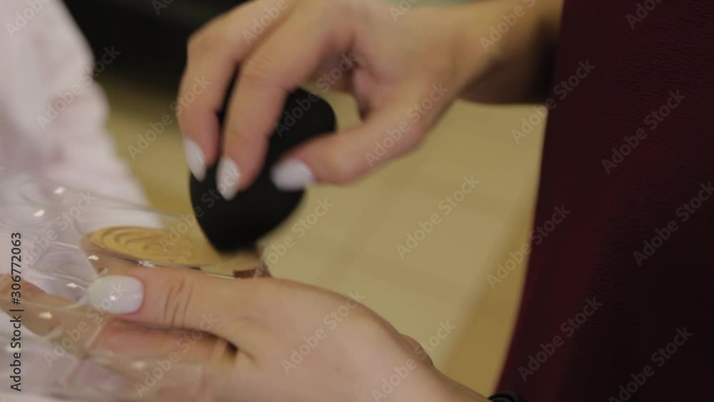 Professional makeup artist with a palette in his hand does makeup. Professional makeup artist with a palette in his hand does makeup.