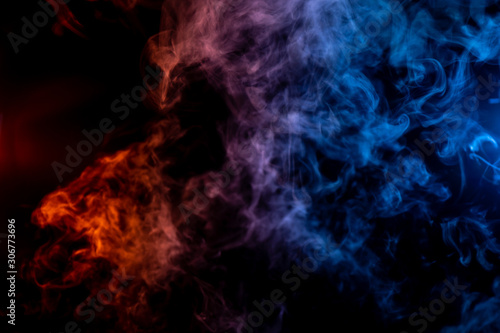 Whispy red purple and blue smoke in shape of a bear head on black background