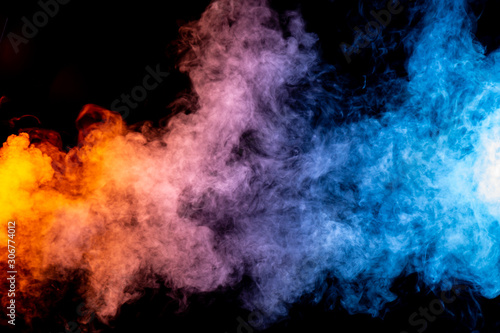 Yellow, Red, and Blue Smoke on Dark Background © Jade Sterling