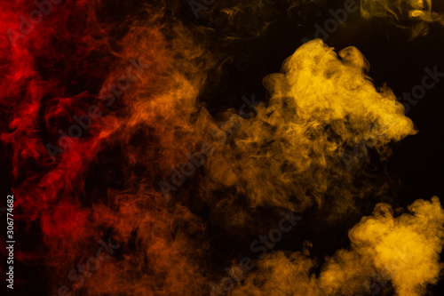Billowing red and yellow smoke on black background