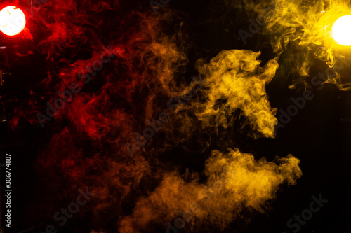 red and yellow stage lights with smoke  on black background