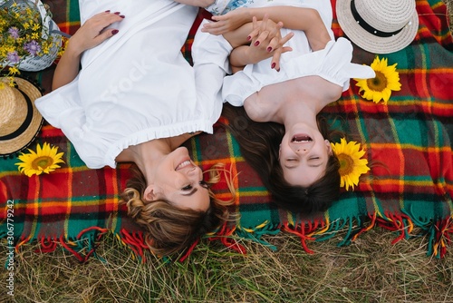 Wallpaper Mural Top view of happy woman smiling and playing with her cute little child, lying outdoor.Loving mother and daughter spend time together in a park. Mom and kid has fun. Mother's day Torontodigital.ca