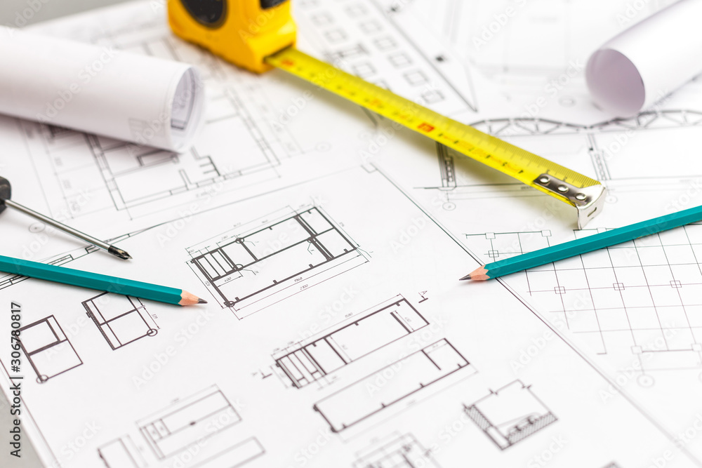 Architectural project, blueprints, blueprint rolls, ruler and pencil. Construction background. Architectural project, blueprints, blueprint rolls, ruler and pencil. Construction background.