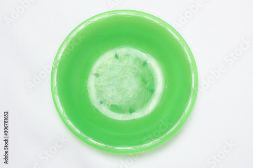 empty green plastic plates top view on white background