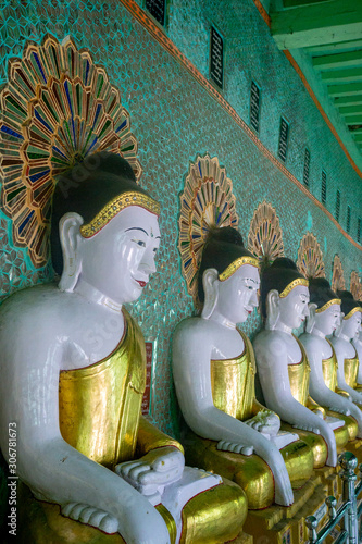 Buddha statues line the wall of the Umin Thonze Pagoda, a Buddhist monastery in Sagaing, on the Ayerwaddy River near Mandalay in Myanmar, formerly called Burma photo