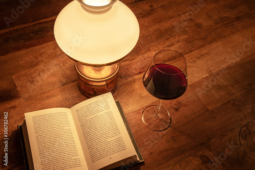 Old table lamp book glass of wine old wooden table