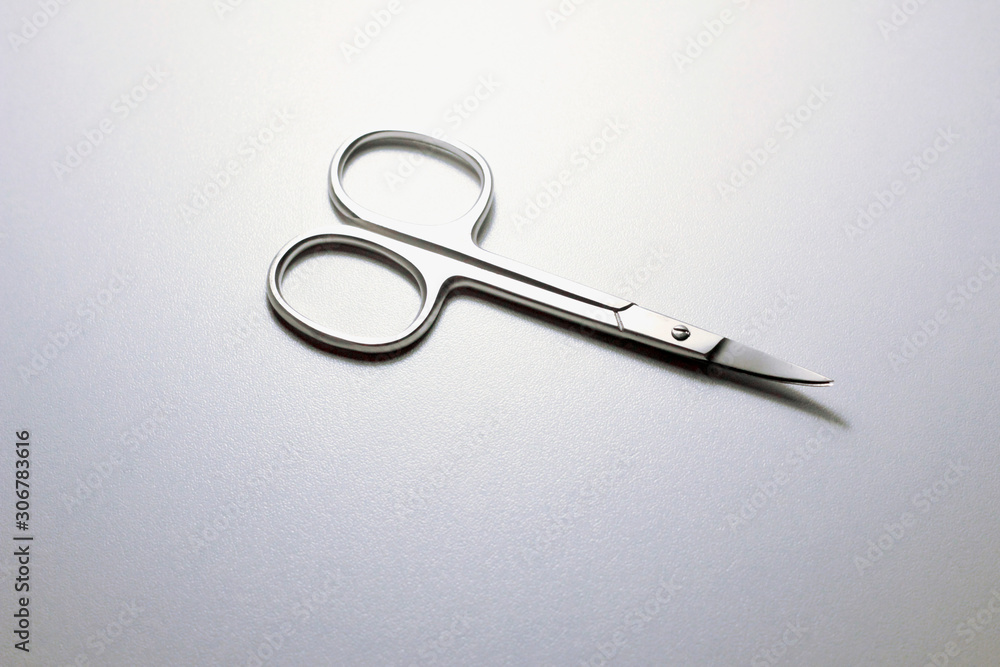 silver steel nail scissors. scissors on a neutral background silver steel nail scissors. scissors on a neutral background