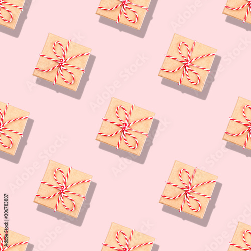 Pattern of Christmas gifts on pink background. Flat lay, top view. © Anna