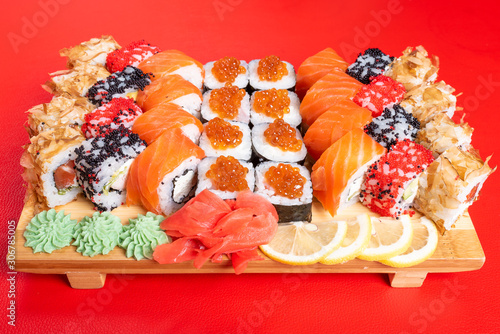 Sushi set of rolls and poppies, with salmon and caviar. With tuna and krill California and Philadelphia. Close-up.