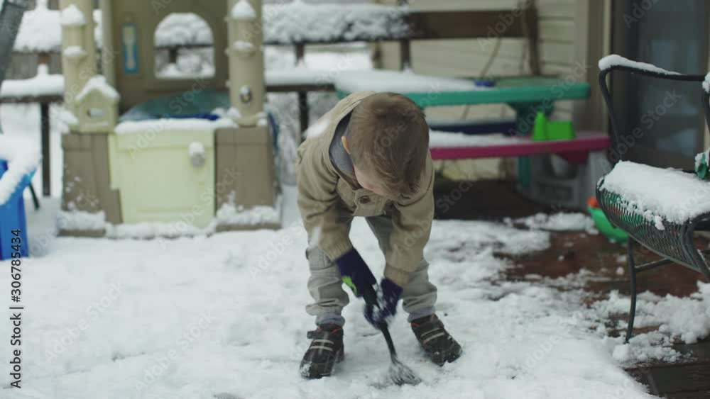 Little boy playing in the snow and laughing in Winter Little boy playing in the snow and laughing in Winter