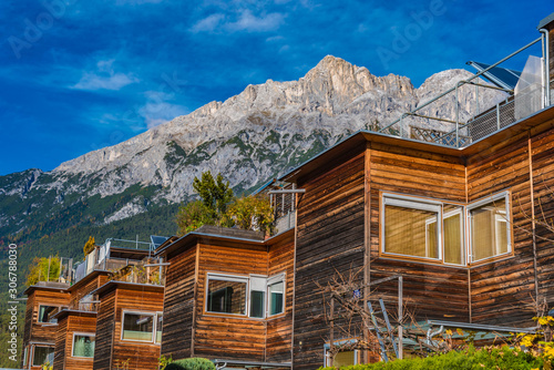residential building with wooden facades in the mountains, telfs, st. wendelin, tyrol, austria photo