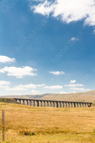 Viaduct with many arches in beautiful countryside, portrait with copyspace.