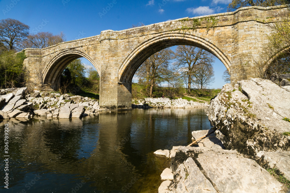Beautiful old stone arch bridge over river. Beautiful old stone arch bridge over river.