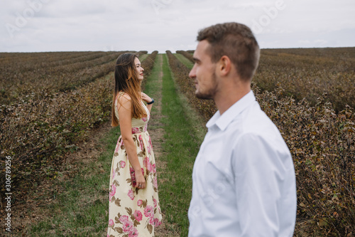 A girl and a guy are walking in the nature. Portrait of a couple, a love story.Happy smiling, loveing couple together outstretched at beautiful nature. Lovestory © Serhii