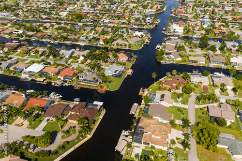 Aerial photos of Cape Coral residence houses and canals with Fort Myers in the background