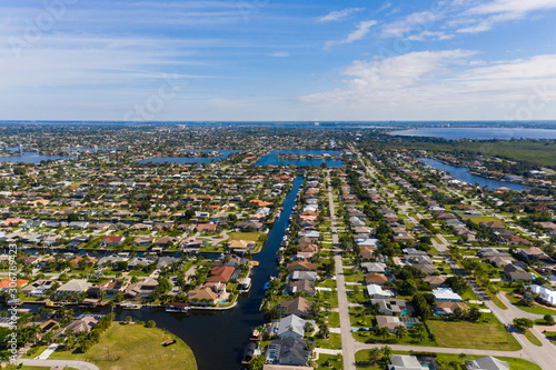 Aerial photos of Cape Coral residence houses and canals with Fort Myers in the background
