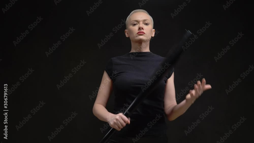 beautiful short haired blond woman with a baseball bat on black background beautiful short haired blond woman with a baseball bat on black background