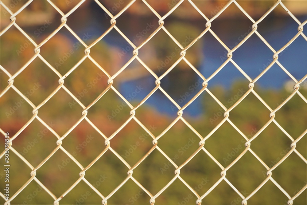 Fototapeta premium View of the lake from the top of stone mountain in Atlanta USA, Aerial view through the white metal fence, Autumn in GA USA.