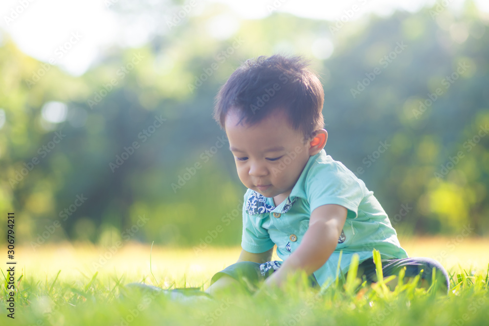 Adorable smart baby boy playing in city green park Adorable smart baby boy playing in city green park